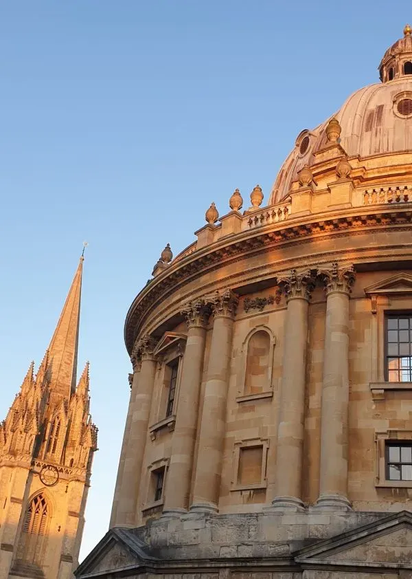 The Radcliffe Camera, Oxford, in evening light, with the University Church in the background